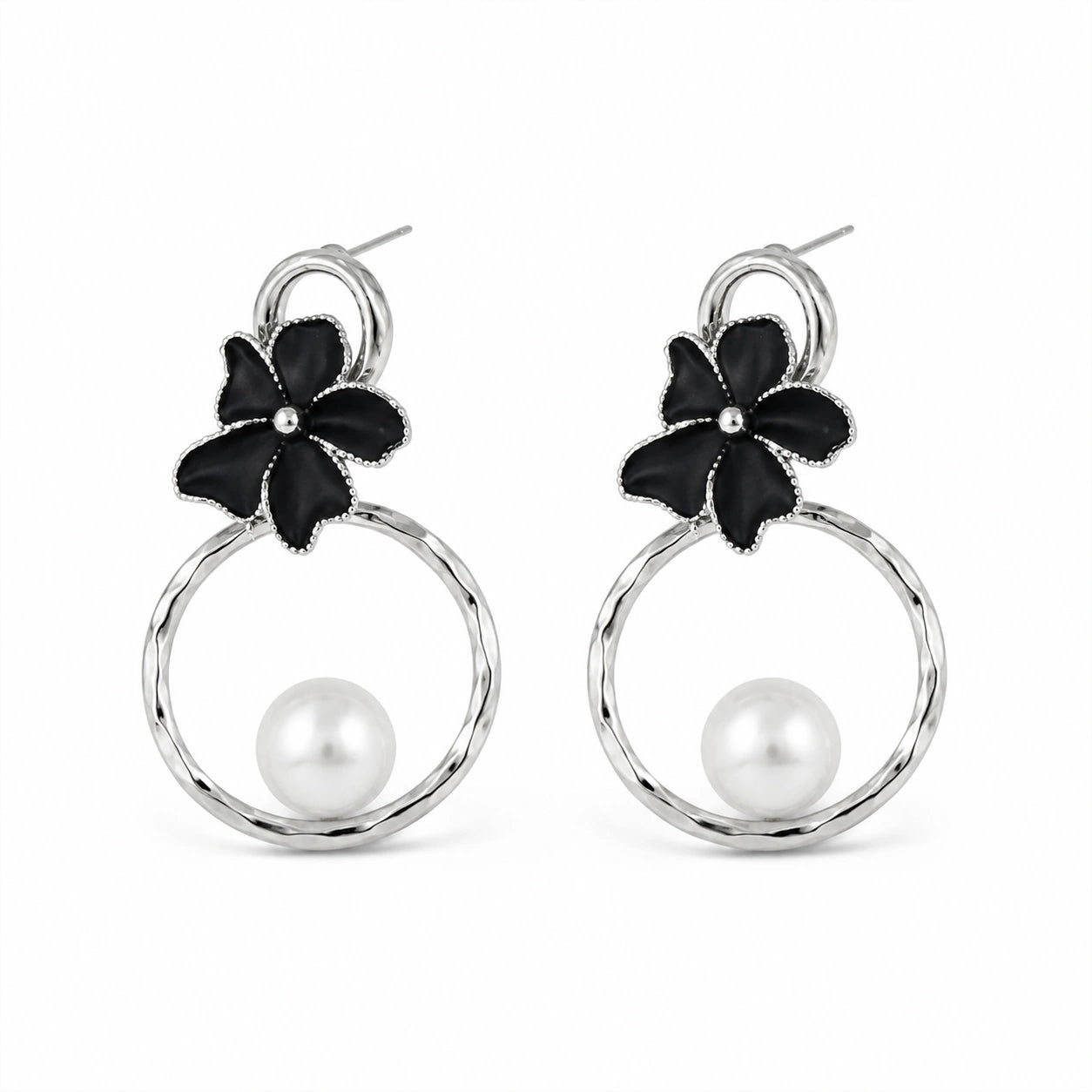 Close-up of black floral elements, silver hoops and pearl-style detailing