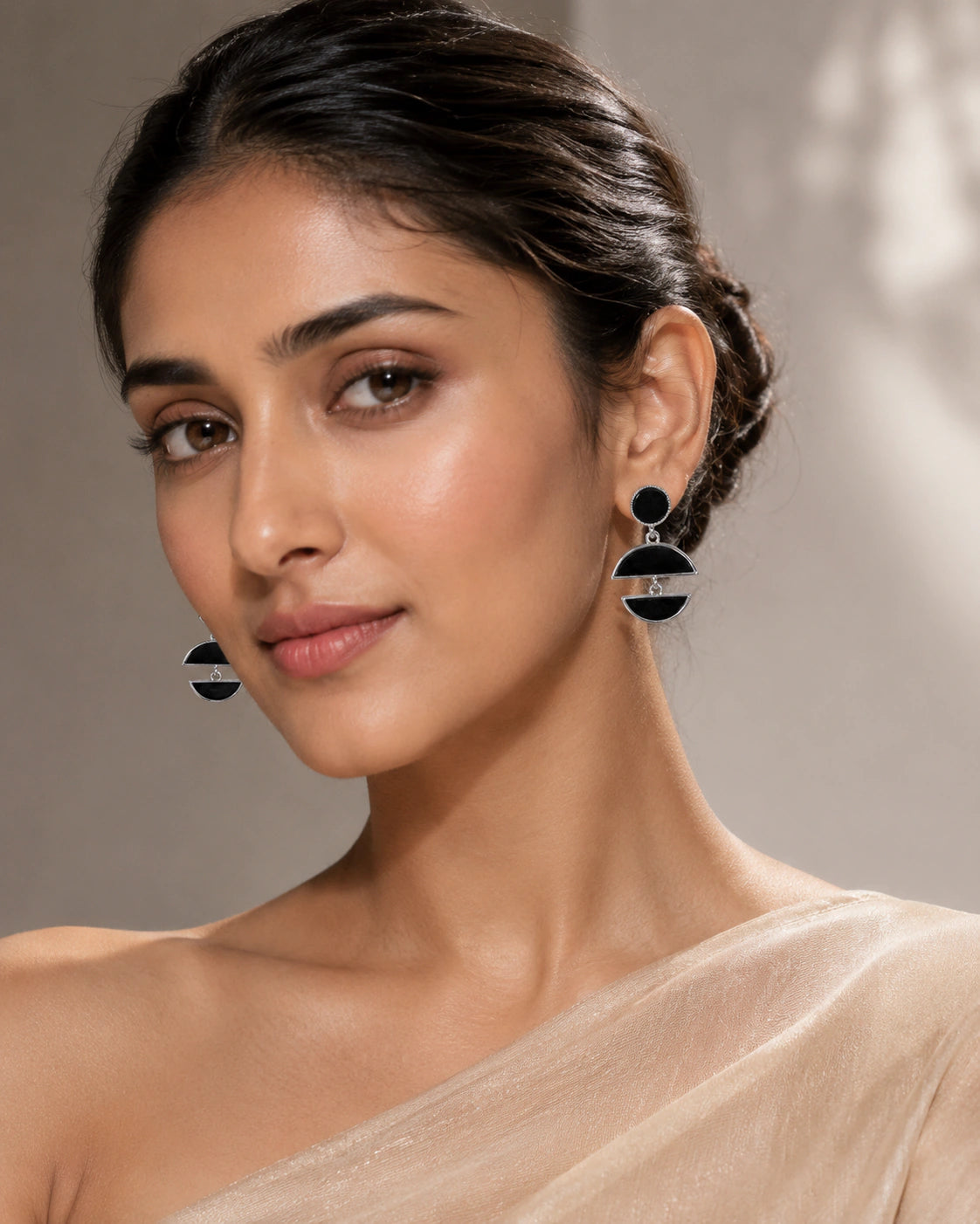 Silver black floral pearl hoop earrings worn by a model
