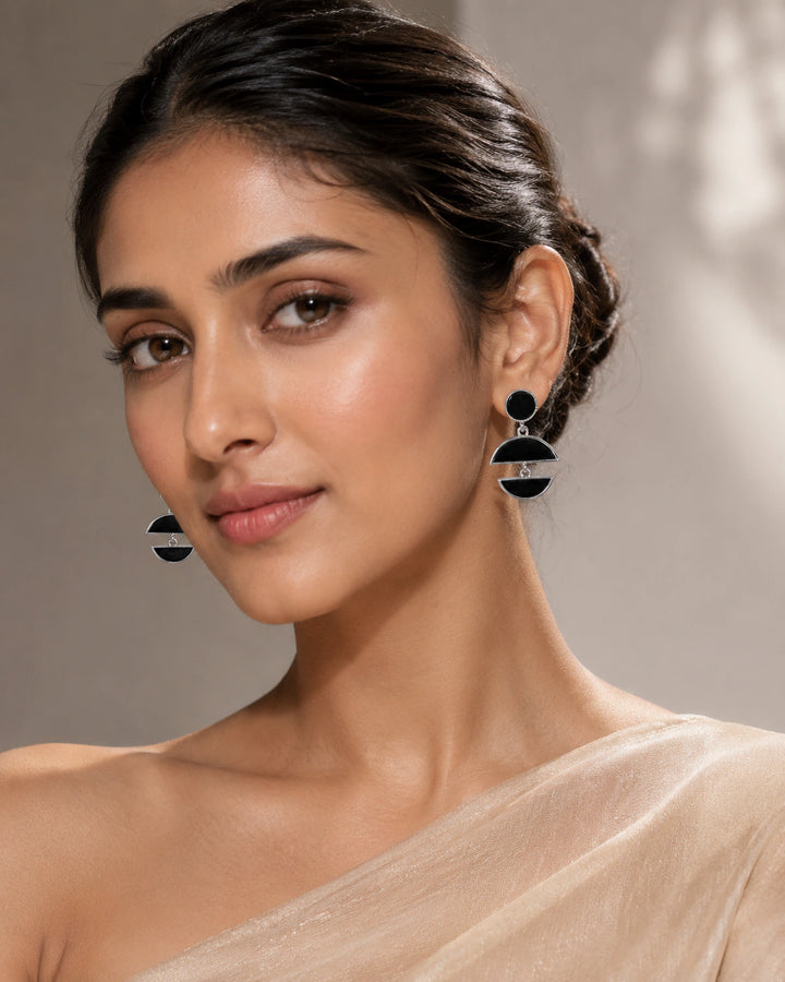 Silver black floral pearl hoop earrings worn by a model