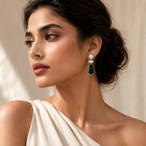 Silver black pearl crystal earrings on a dark jewellery studio display