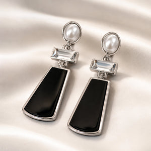 Close-up of black panels, pearl-style drops and crystal detailing