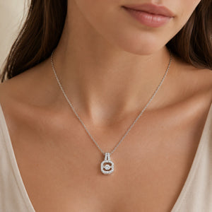 Silver crystal halo pendant necklace on a dark jewellery studio display