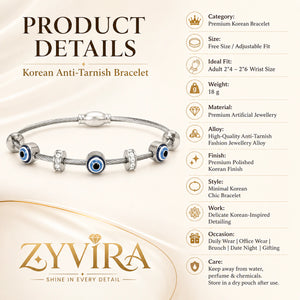 Silver evil-eye charm bracelet styled in an elegant jewellery flat lay