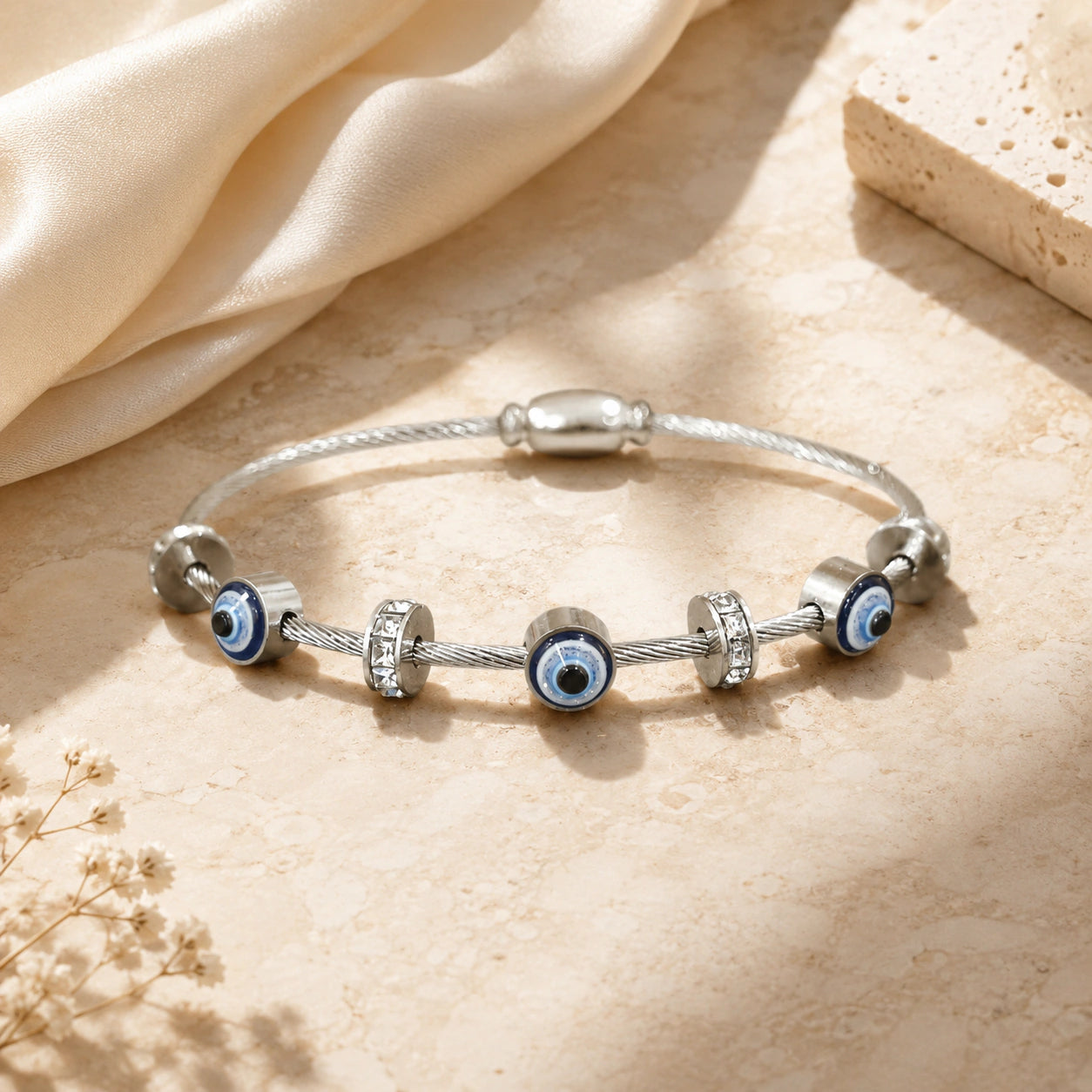 Side view of the silver evil-eye crystal charm bracelet
