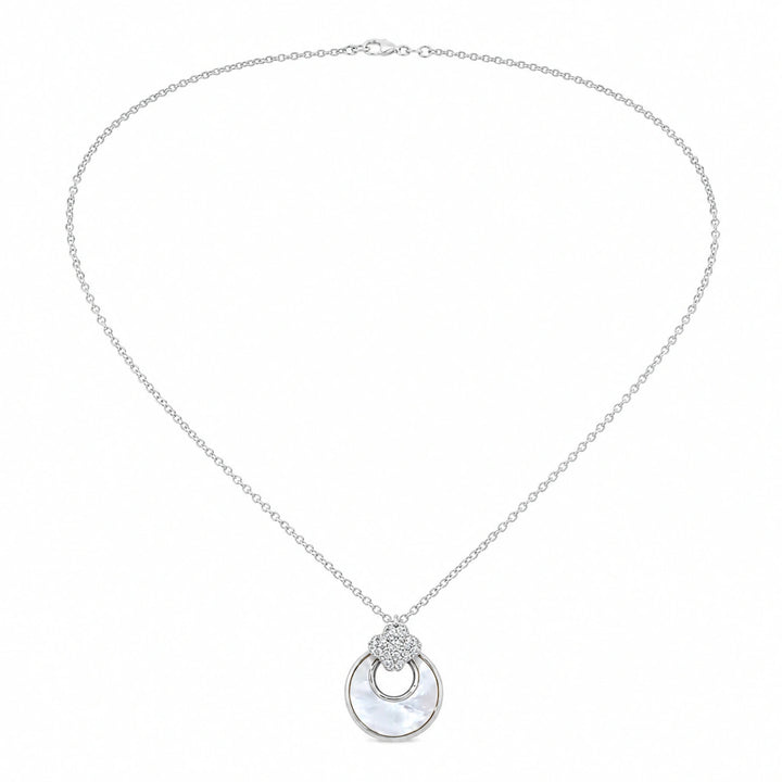 Silver floral crystal halo necklace on a dark jewellery studio display