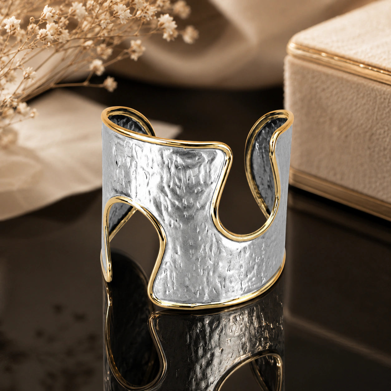 Angled view of the silver-and-gold hammered wave kada