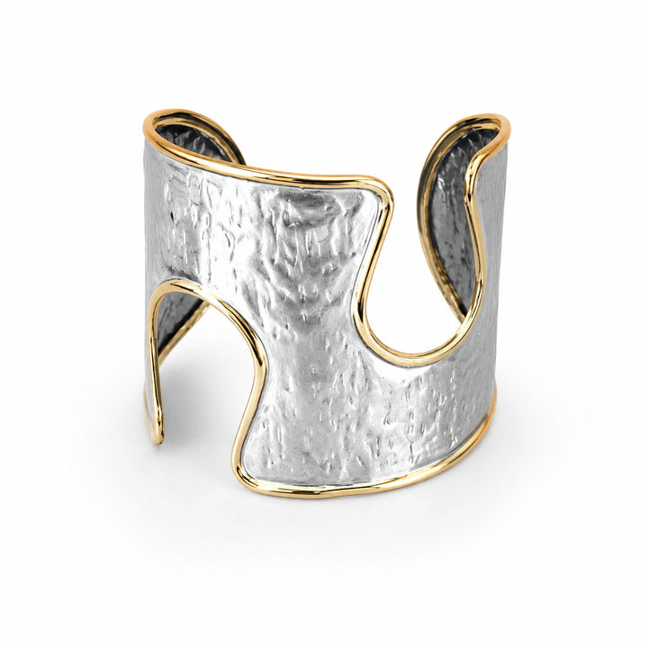 Silver-and-gold hammered wave kada on a dark jewellery studio display