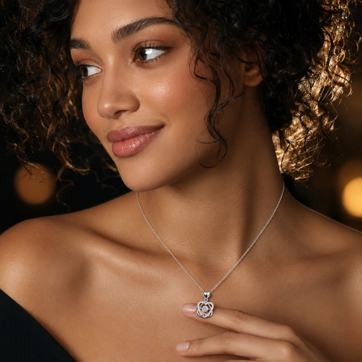 Angled view of the silver interwoven heart crystal necklace