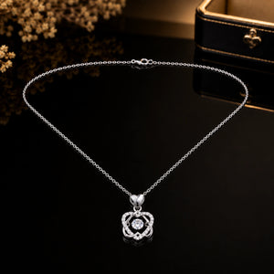 Close-up of the interwoven heart and crystal pendant detailing