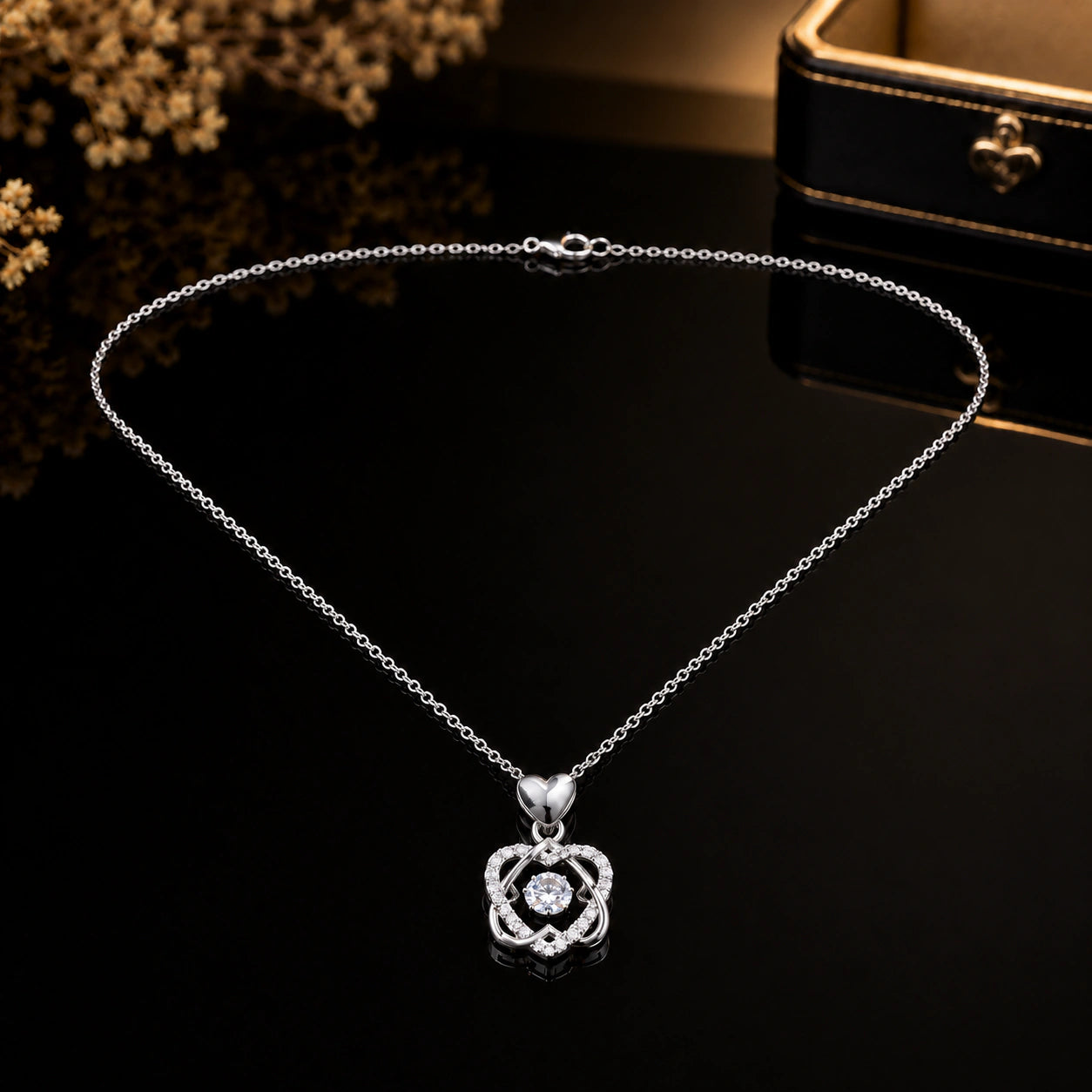 Close-up of the interwoven heart and crystal pendant detailing