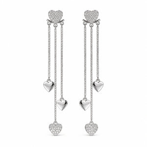 Angled view of silver pavé heart triple-chain earrings