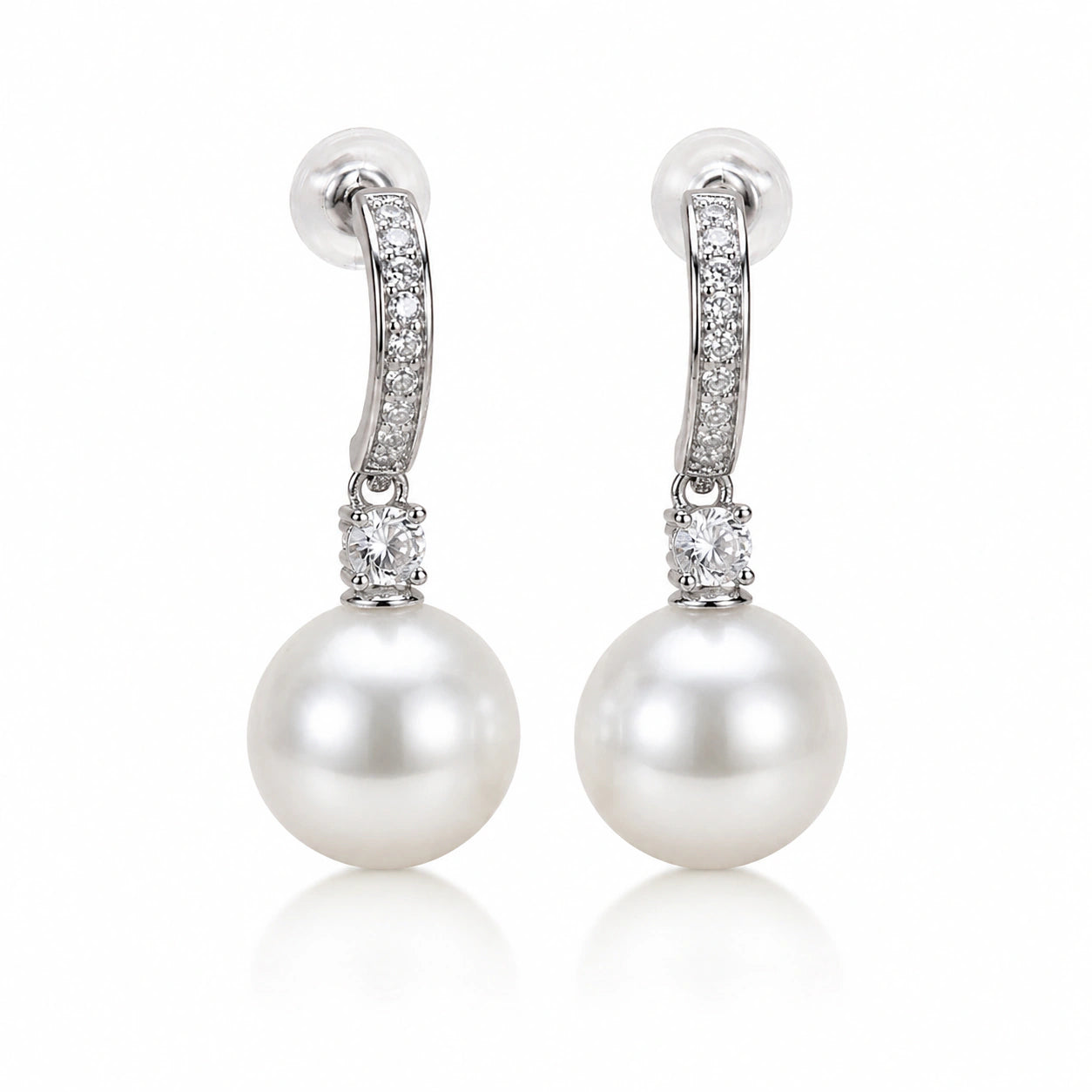 Silver pearl crystal-style drop earrings styled in an elegant jewellery flat lay