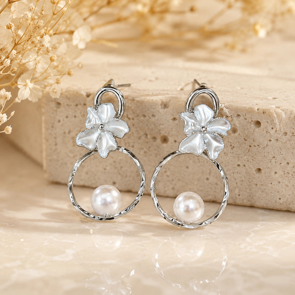 Silver pearl floral hoops styled in a modern jewellery flat lay