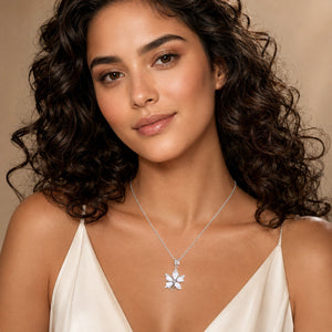 Angled view of the silver pearl-style floral pendant necklace