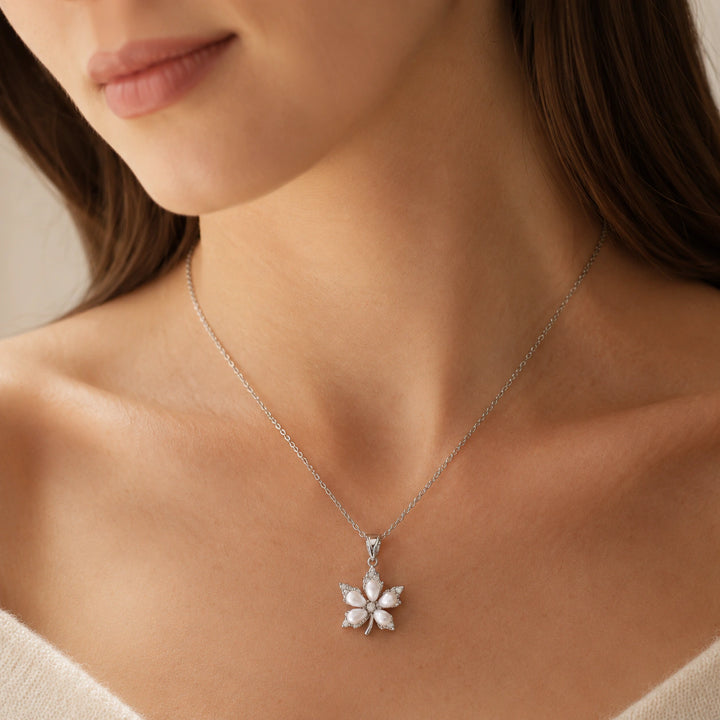 Silver pearl floral necklace on a dark jewellery studio display