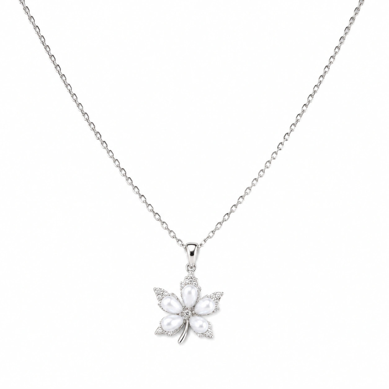 Silver pearl floral necklace styled in an elegant jewellery flat lay
