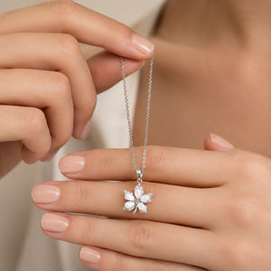 Close-up of the pearl-style floral pendant detailing