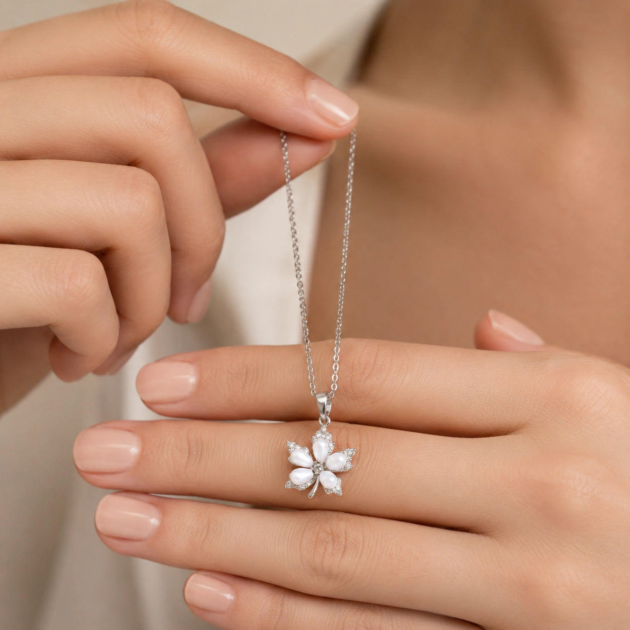 Close-up of the pearl-style floral pendant detailing