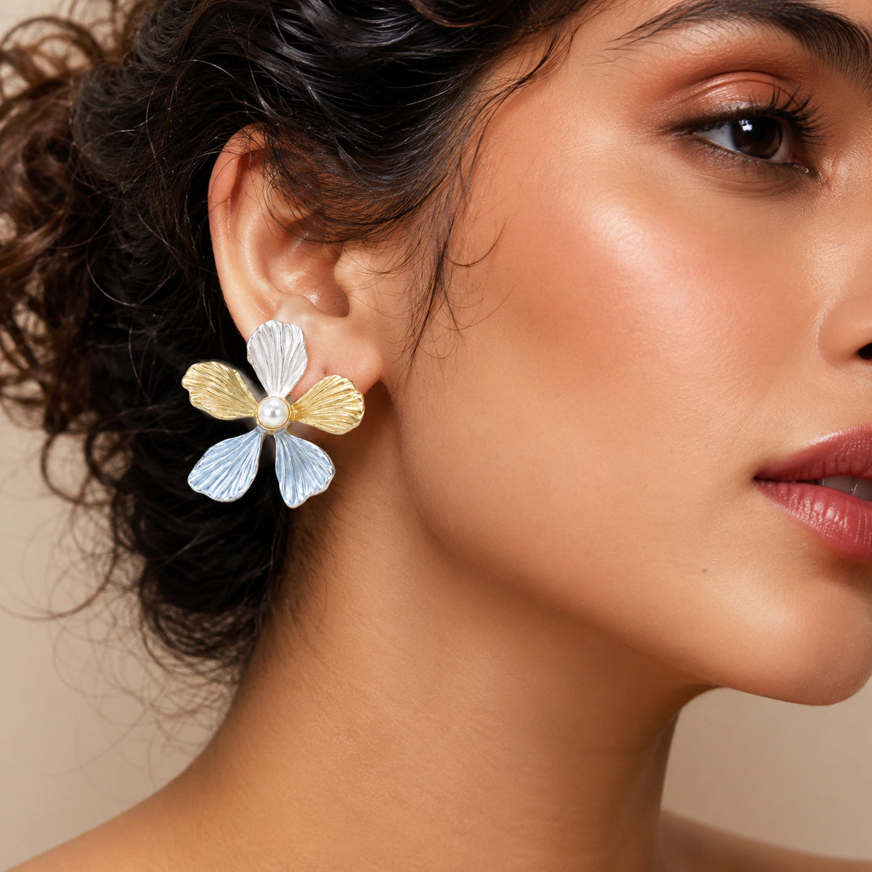 Sky blue floral pearl earrings styled in a modern jewellery flat lay