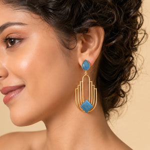 Angled view of sky blue gold geometric chandelier earrings