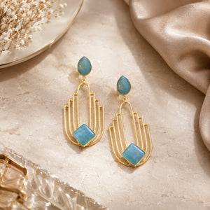 Sky blue chandelier earrings styled in a modern jewellery flat lay