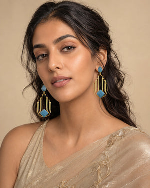 Sky blue gold geometric chandelier earrings worn by a model