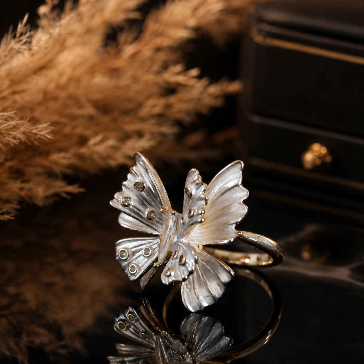 Angled view of the two-tone crystal butterfly ring