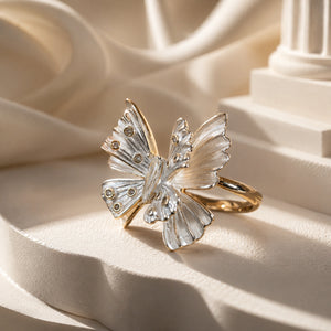 Two-tone butterfly ring styled in an elegant jewellery flat lay