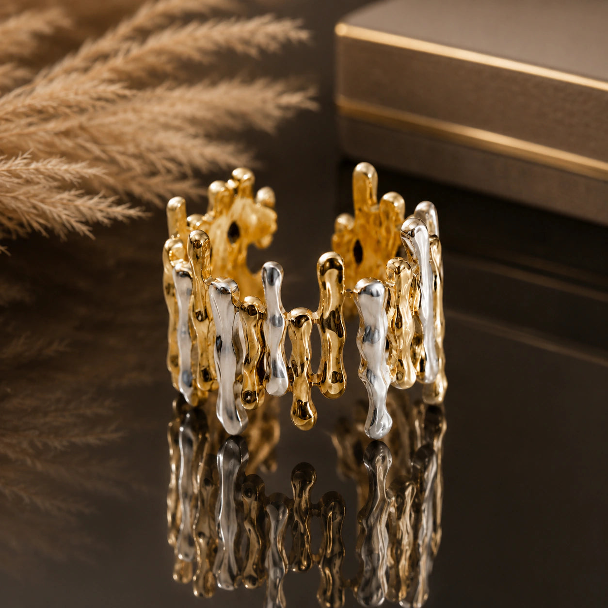 Two-tone molten drip ring styled in an elegant jewellery flat lay