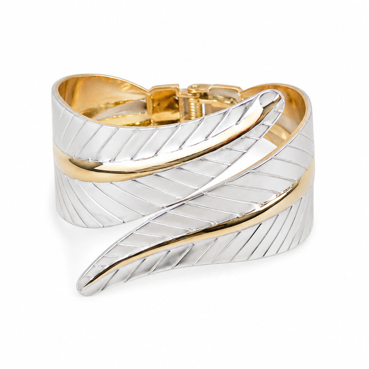 Two-tone ribbon-leaf kada on a dark jewellery studio display