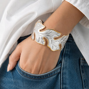 Angled view of the two-tone sculptural leaf kada