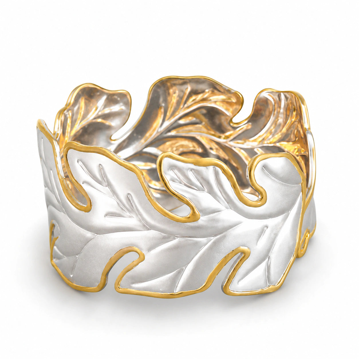 Two-tone sculptural leaf kada on a dark jewellery studio display